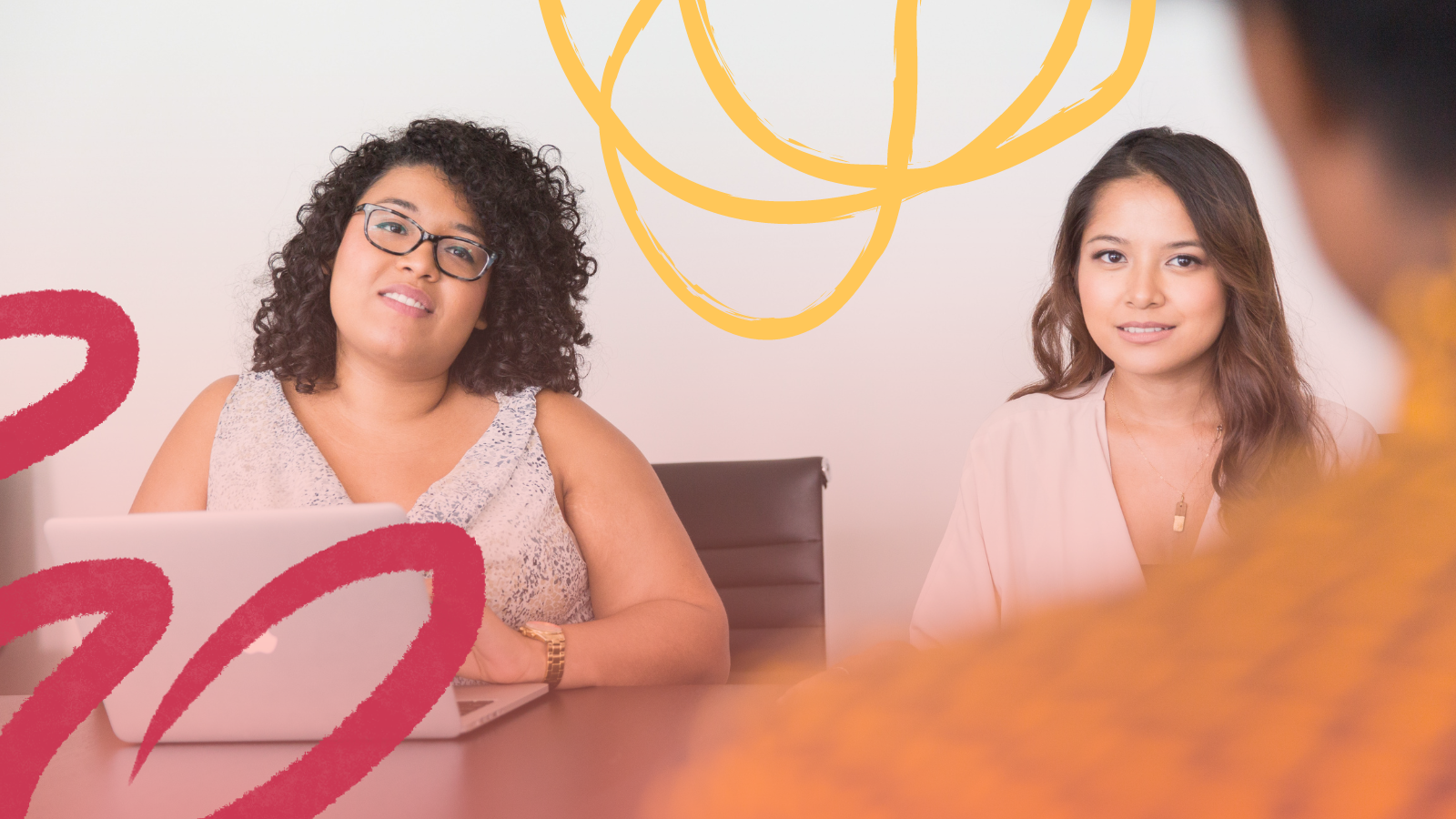 Two young women sit across from someone at a meeting table. They are looking at the person in the forefront having a conversation with them. The person in front is out of focus. A few colorful sketch elements are layered over the image.